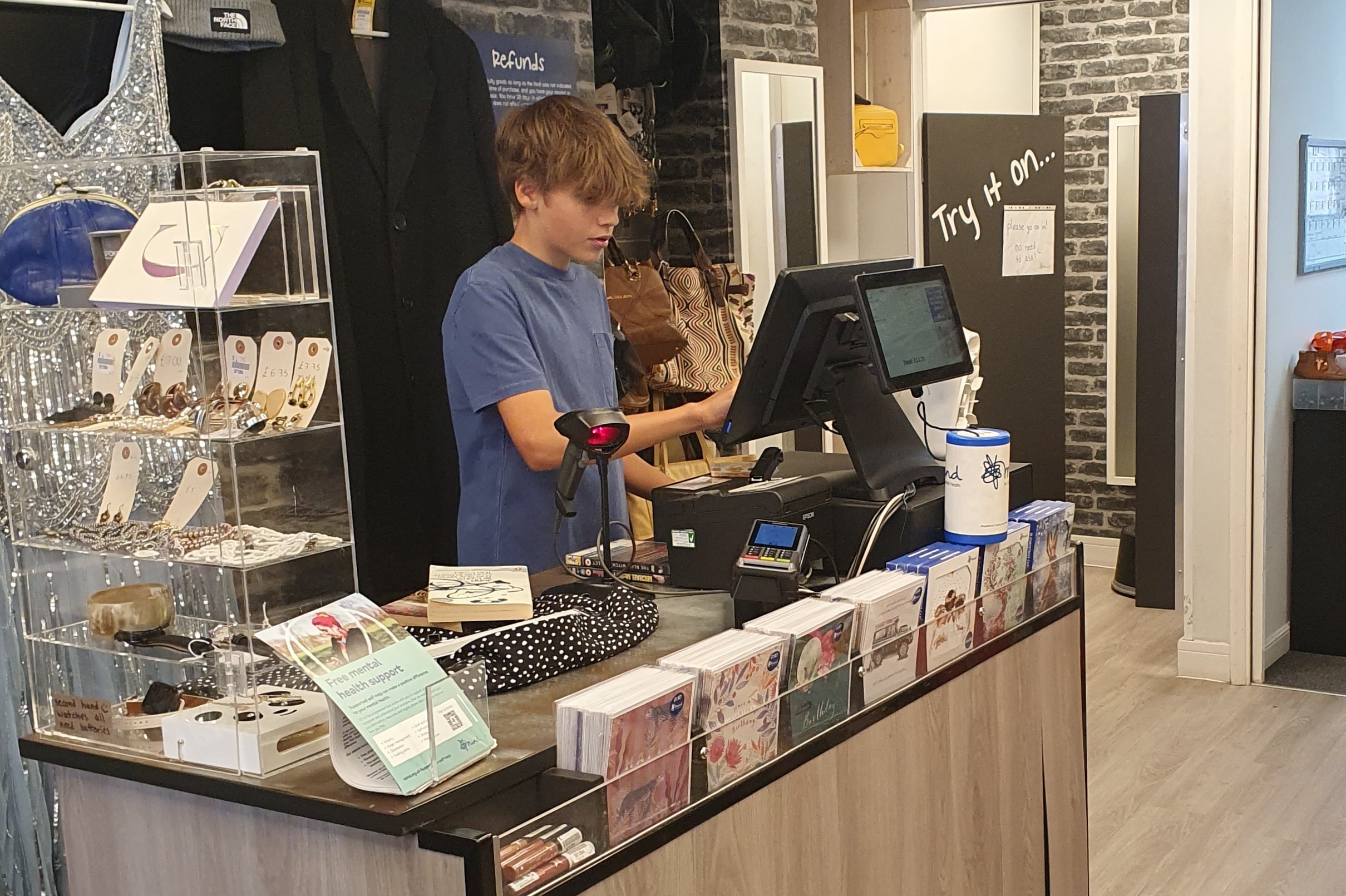 Me on the till in a Mind charity shop