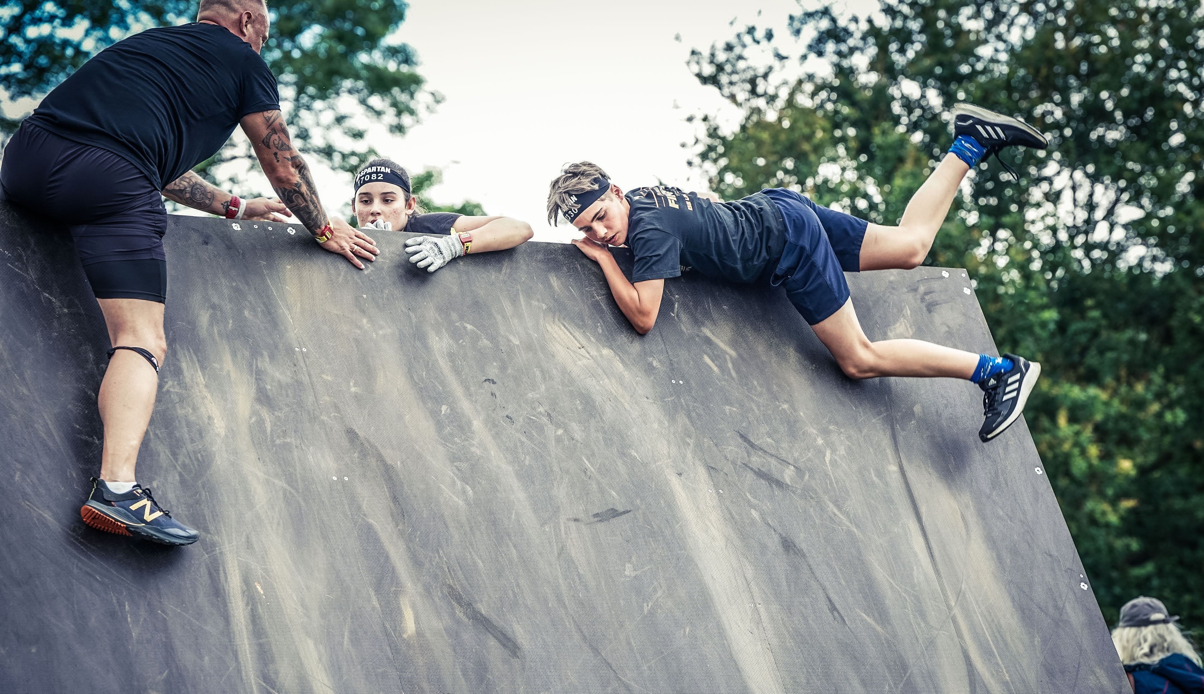 Me in a spartan race, climbing a steep wall